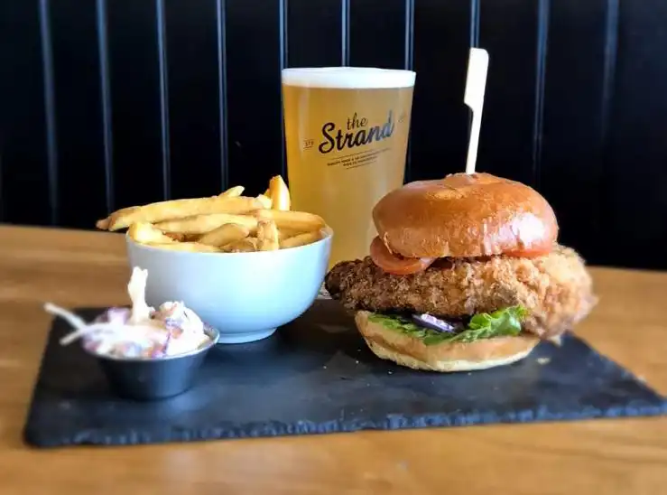 A chicken burger, fries and a pint at The Strand