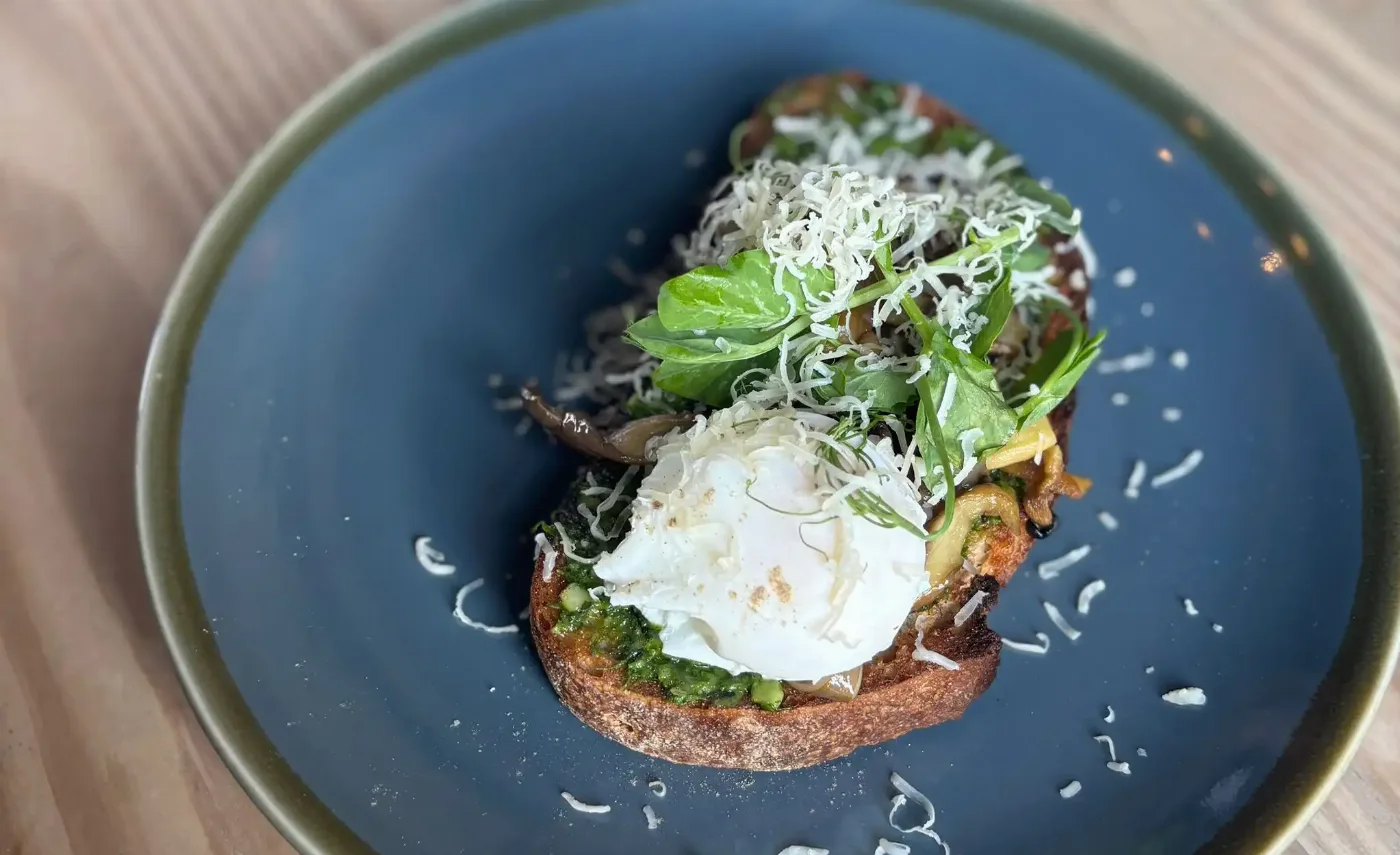 Poached egg, mushrooms and greens on toast photographed at The Strand